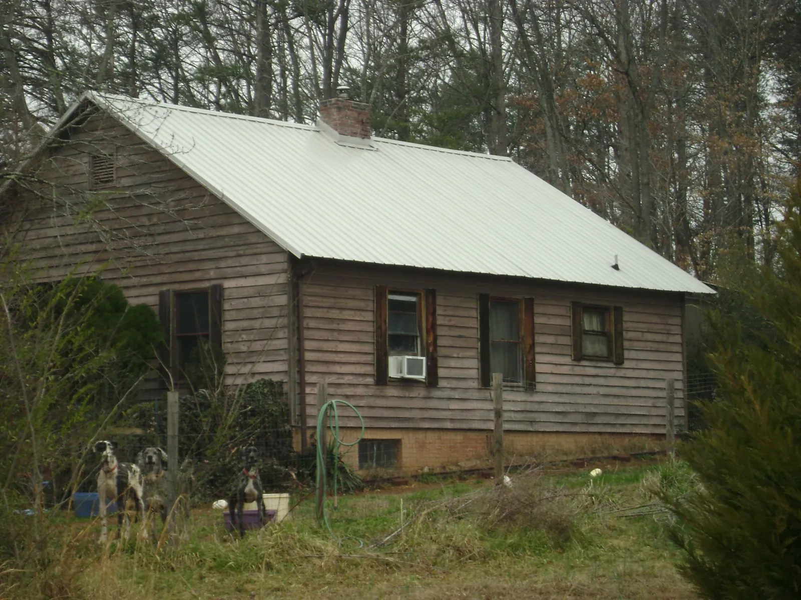 White metal roof on an old wood sided farmhouse in Oakland